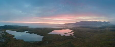 Foggy morning in greenland. Airial shot, drone photo. Colorful landscape background concept