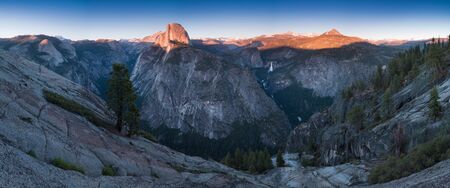 Half Dome and Yosemite Valley in Yosemite National Park during colorful sunset with trees and rocks. California, USA Sunny day at the most popular viewpoint in Yosemite. Beautiful landscape backgroundの写真素材