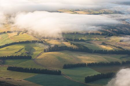 The valley is flooded in mist in a mountain environment. Over the fogs, only the high peaks of the...