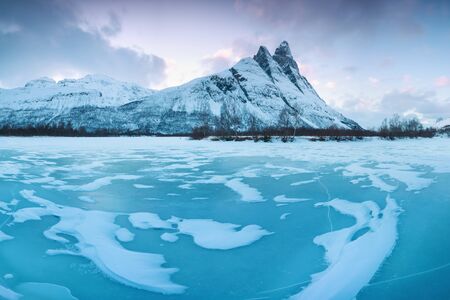 Beautiful landscape scene with the Signaldalelva river and Otertinden mountain in the background in...