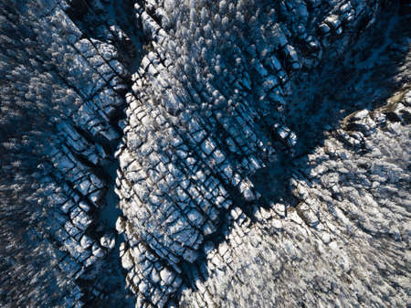 Aerial view of snow-covered forest in winter. Drone photography.の写真素材