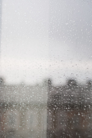 Raindrops on window, city as a backgroundの写真素材