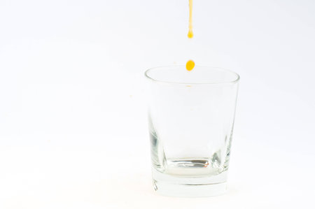 Photo of glass with whisky against white background