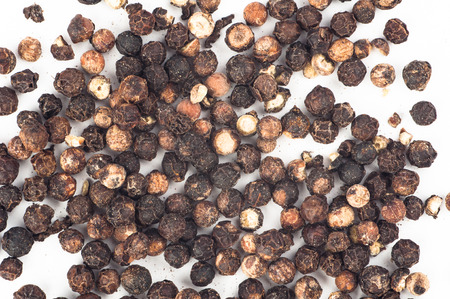 Photo of black pepper against white background