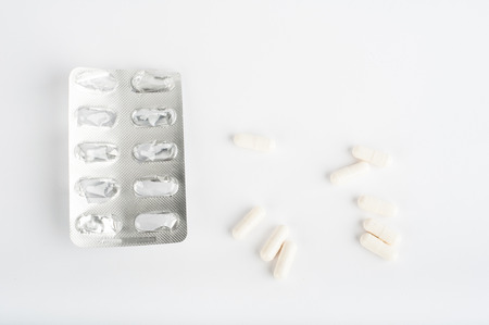 Photo of medicine pills on white background