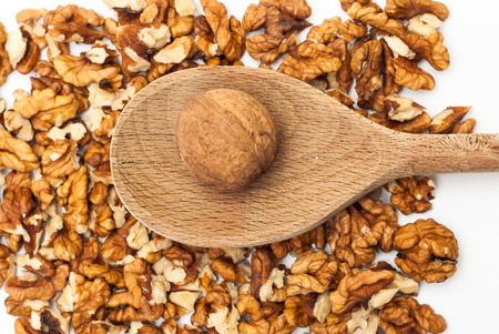 Photo of walnut on wooden spoon against nut backgroundの写真素材