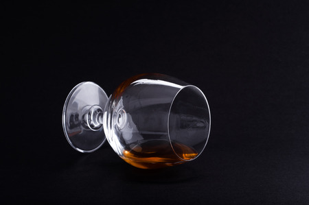 Photo of cognac in glass against black backgroundの写真素材