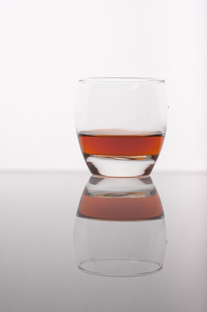 Photo of whisky in the glass against white backgroundの写真素材