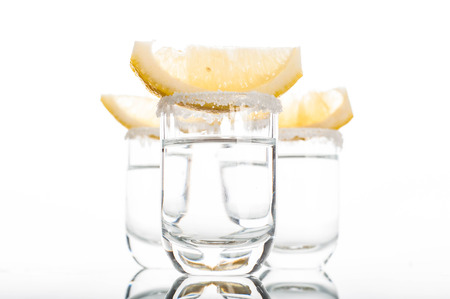 Photo of Three shots of vodka with lime sliceの写真素材