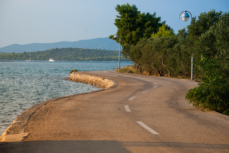 Photo of asphalt road near blue seaの写真素材