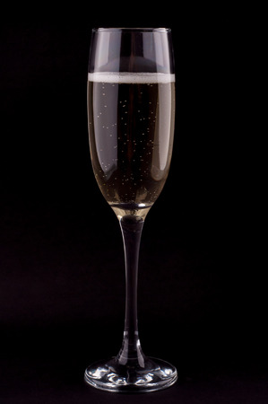 Photo of a glass of champagne on black backgroundの写真素材