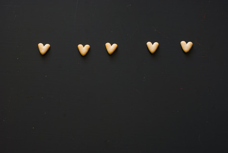 photo of crackers hearts on dark wooden tableの写真素材