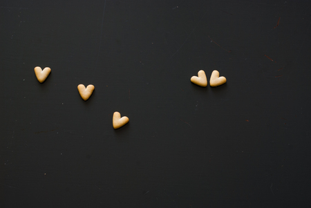 photo of crackers hearts on dark wooden tableの写真素材