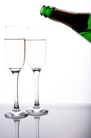 Photo of two glasses of champagne on white backgroundの写真素材