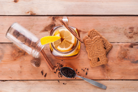 Photo of Hot spiced tea in jar on wooden tableの写真素材