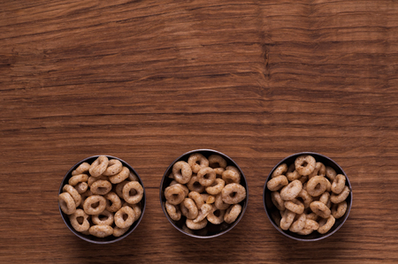 Photo of cereals in metal bowl on brown wooden tableの写真素材
