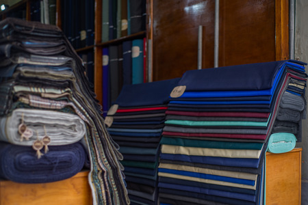 Photo of Rolls of textiles in a fabric shop. Multi colors and patterns.の写真素材