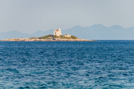 Photo of Beautiful summer seascape with lighthouse on the island in Orebic, Peljesac peninsula, Dalmatia, Croatiaの写真素材