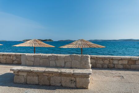 Photo of Beautiful summer seascape with sun umbrellas in Orebic, Peljesac peninsula, Dalmatia, Croatiaの写真素材