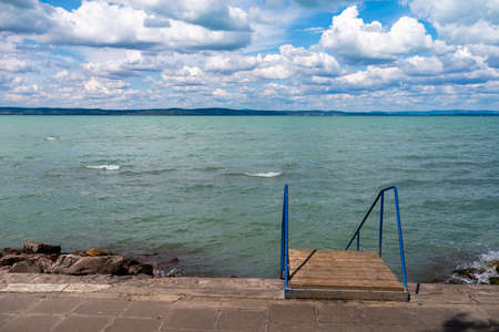 Photo of Balaton Lake in Siofok, Hungary. Dramatic Cloudy sky and blue, tourquise water.の写真素材