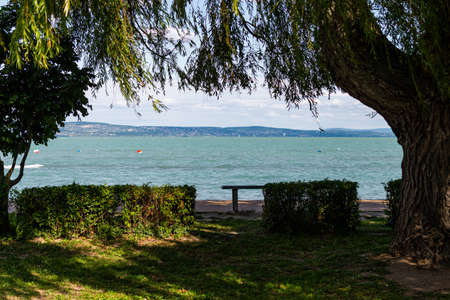 Photo of Balaton Lake in Siofok, Hungary. Dramatic Cloudy sky and blue, tourquise water.の写真素材