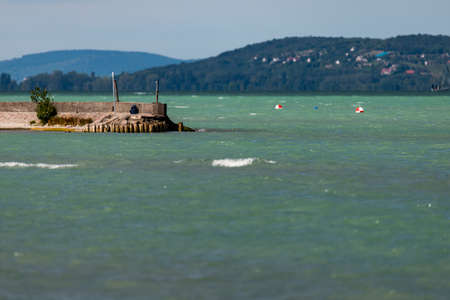 Photo of Balaton Lake in Siofok, Hungary. Dramatic Cloudy sky and blue, tourquise water.の写真素材