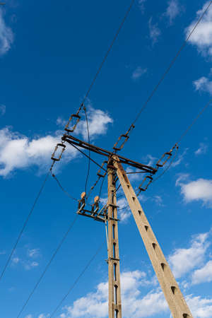 Photo of Power transmission tower with blue sky as background. Air electric lines.
