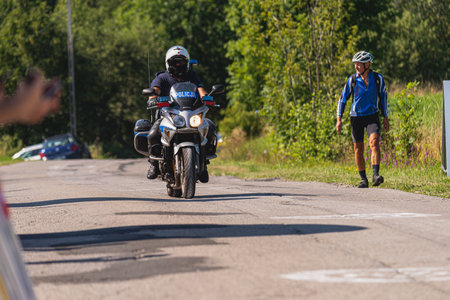 BUDZOW, POLAND - AUGUST 5, 2022: Cycling race "Tour de Pologne" 2022, stage 7 from Skawina to Krakow, professional cyclist riding uphill (KoM in BudzÃ³w)のeditorial素材