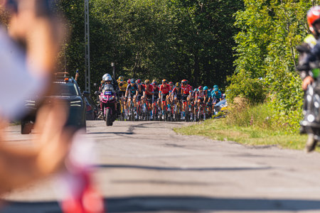 BUDZOW, POLAND - AUGUST 5, 2022: Cycling race "Tour de Pologne" 2022, stage 7 from Skawina to Krakow, professional cyclist riding uphill (KoM in BudzÃ³w)のeditorial素材
