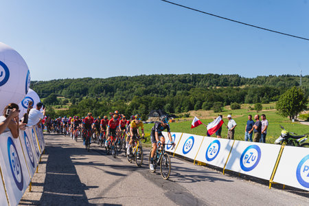 BUDZOW, POLAND - AUGUST 5, 2022: Cycling race "Tour de Pologne" 2022, stage 7 from Skawina to Krakow, professional cyclist riding uphill (KoM in BudzÃ³w)のeditorial素材