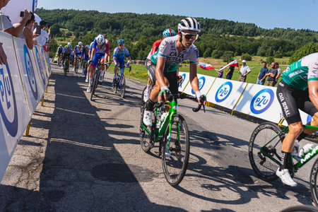 BUDZOW, POLAND - AUGUST 5, 2022: Cycling race "Tour de Pologne" 2022, stage 7 from Skawina to Krakow, professional cyclist riding uphill (KoM in BudzÃ³w)のeditorial素材