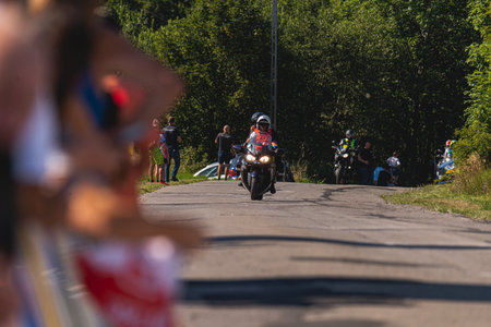 BUDZOW, POLAND - AUGUST 5, 2022: Cycling race "Tour de Pologne" 2022, stage 7 from Skawina to Krakow, professional cyclist riding uphill (KoM in BudzÃ³w)のeditorial素材
