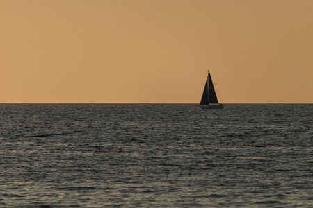 Photo of Small sailing boat on the Baltic Sea. golden hour.