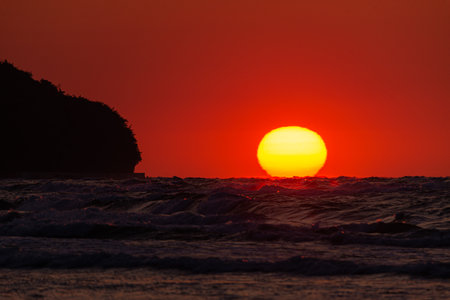 Photo of Sunset over stormy waves on Baltic Sea. golden hour.の写真素材