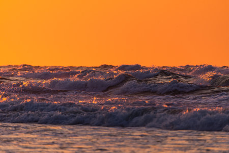 Photo of Stormy waves on Baltic Sea. golden hour.の写真素材