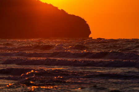 Photo of Stormy waves on Baltic Sea. golden hour.の写真素材