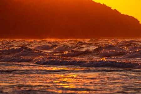 Photo of Stormy waves on Baltic Sea. golden hour.の写真素材
