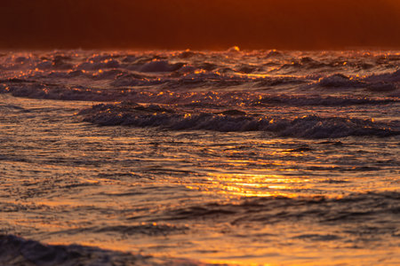 Photo of Stormy waves on Baltic Sea. golden hour.の写真素材