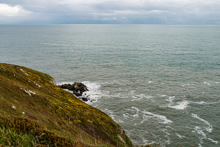 Photo of Howth Cliffs, Dublin, Ireland. Cloudy landscape with Ireland coastline and North Sea. Howth...