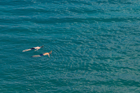 Photo of Two people snorkeling in the seaの写真素材