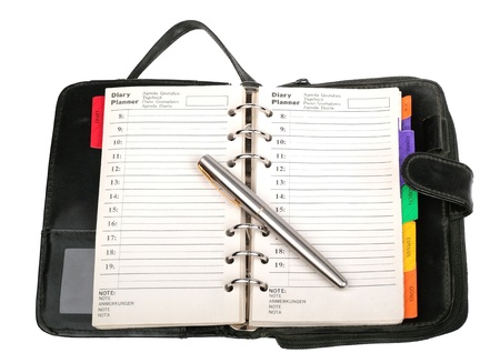 Black personal organizer with a  pen isolated on white backgroundの写真素材