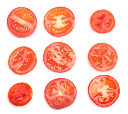 Fresh tomatoes slices isolated on white backgroundの写真素材