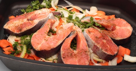 Salmon steaks with vegetables on the cook griddle prepared for the ovenの写真素材