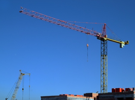 Tower crane over the blue sky under the sunlightの写真素材