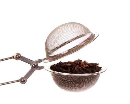 Black tea in strainer isolated on white backgroundの写真素材
