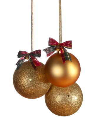 Three gold Christmas balls isolated on white backgroundの写真素材