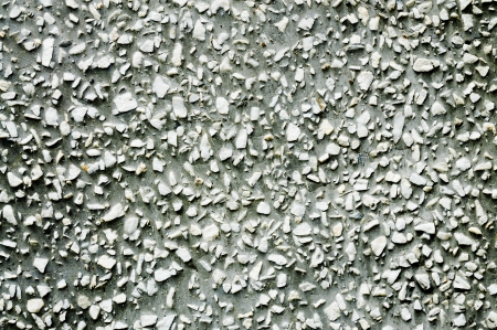 Many small gray stones arranged in the texture of a convex shape