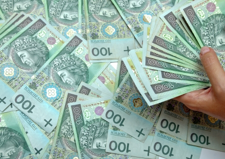 Female hand is on the banknotesの写真素材