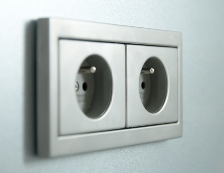 Electrical outlets at home against a gray wallの写真素材