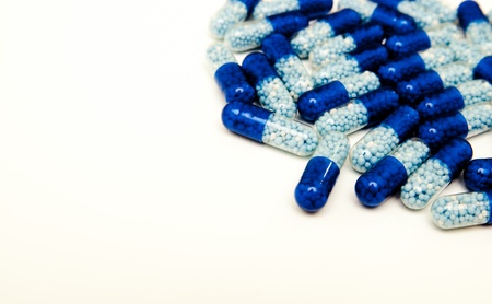 Scattered blue pills in the right corner of the frameの写真素材